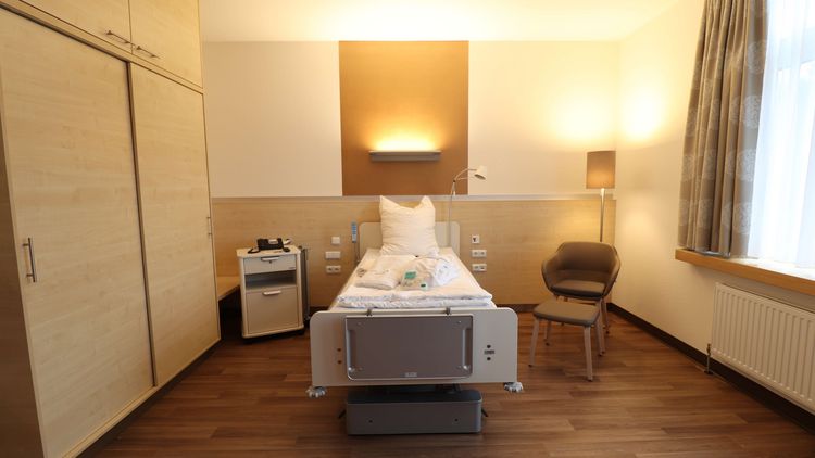 Wahlleistungszimmer mit Bett und Nachttisch